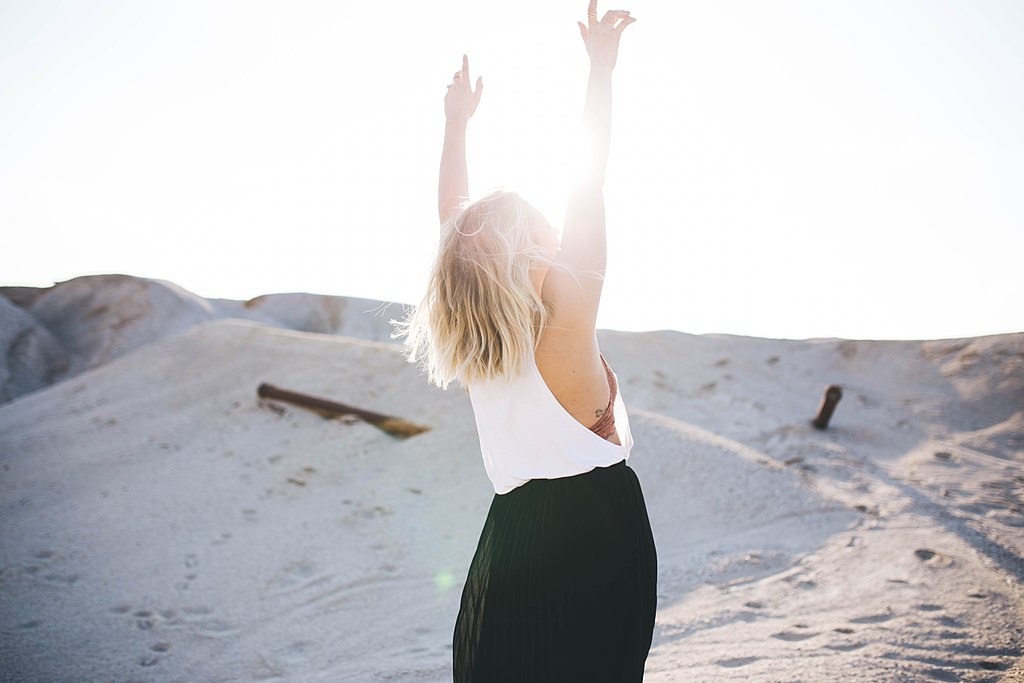 1024px-Woman_lifting_up_her_hands_(Unsplash)